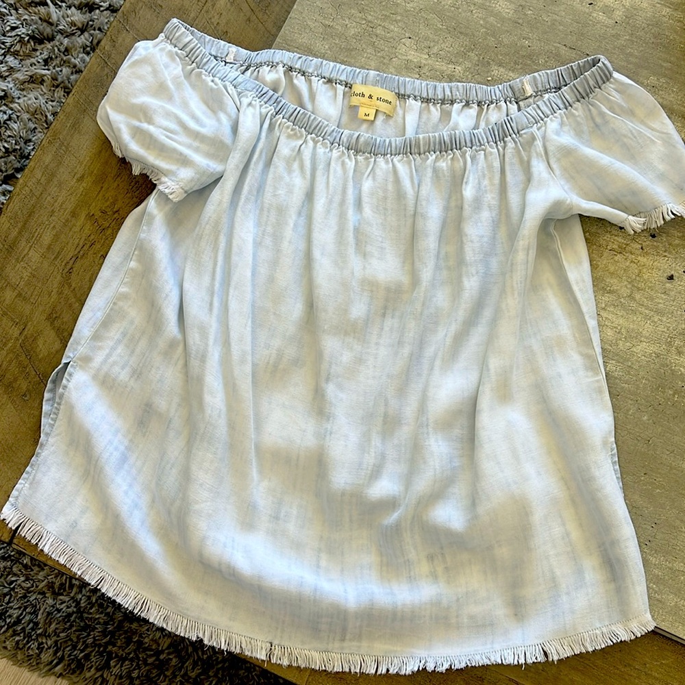 Light colored jean off shoulder top in size medium.